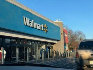 Fachada moderna de Walmart en Florida con clientes hispanos en la entrada y elementos de salud y bienestar visibles