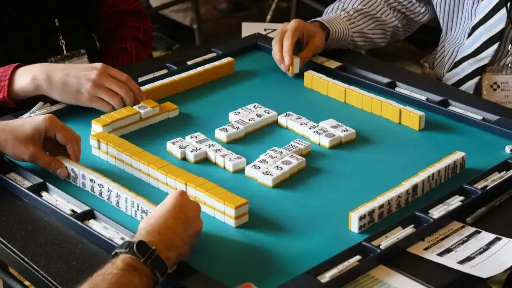Mahjong como actividad social en grupos que se reúnen para jugar y aprender en la ciudad
